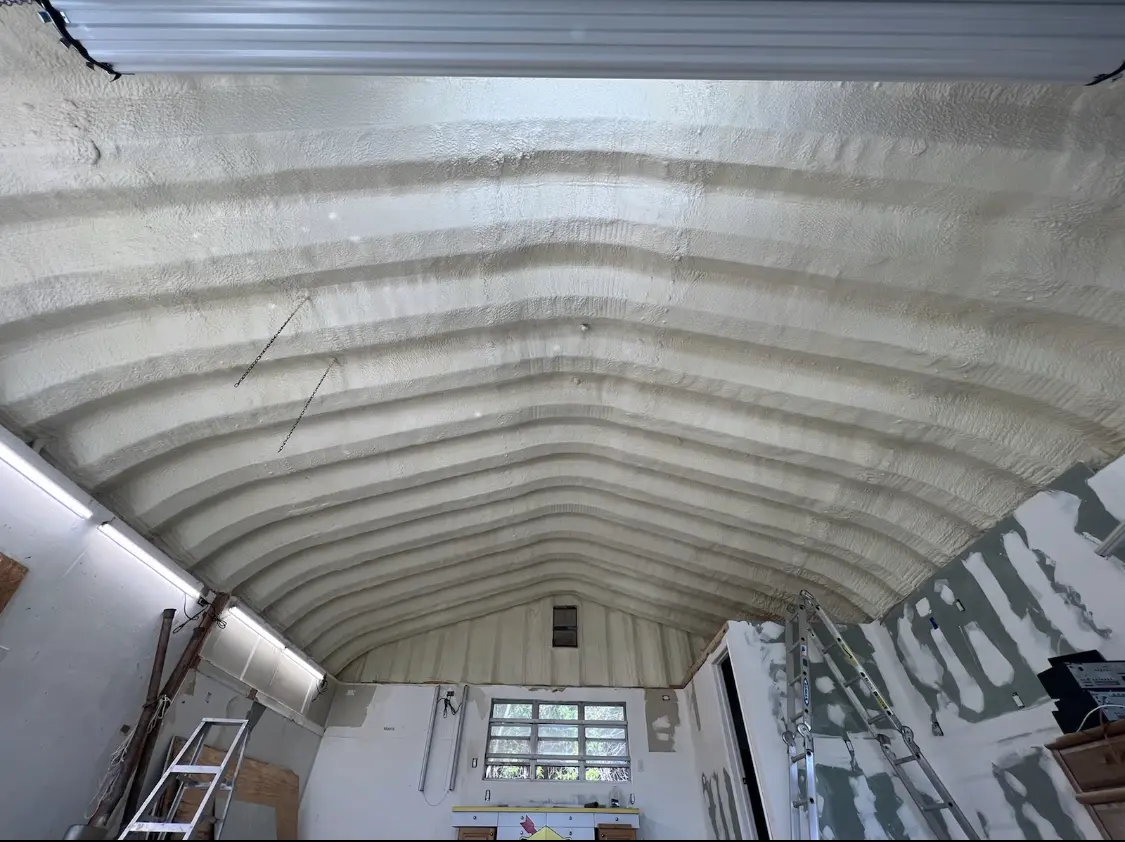 Spray polyurethane foam applied to the underside of a metal roof deck in Manistee